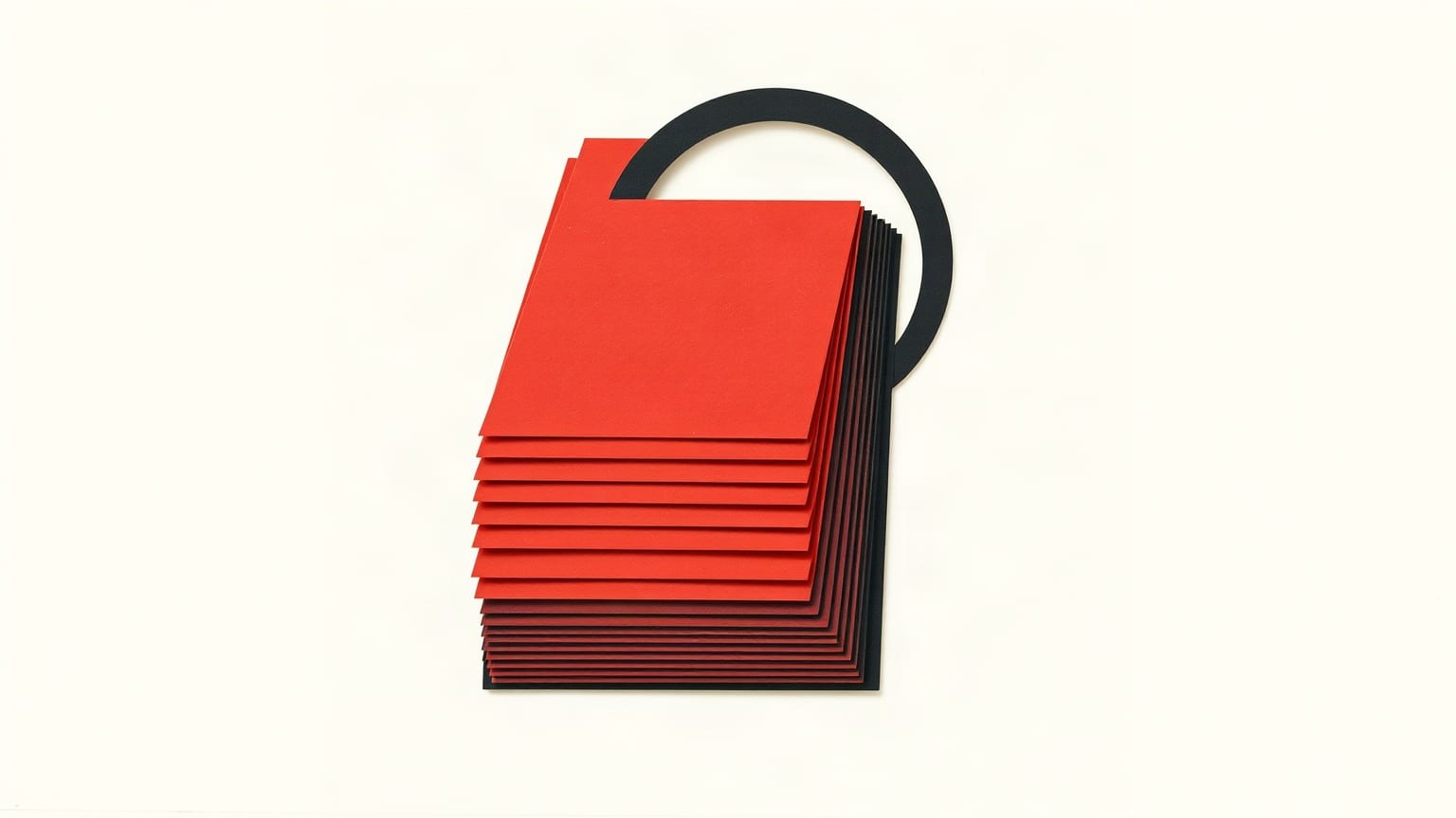 A fanned stack of red paper rectangles with a dark aperture ring resting over them