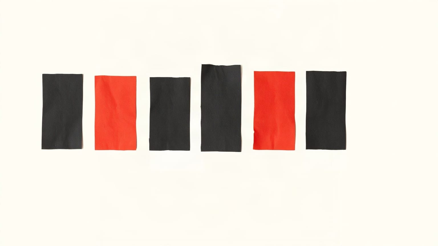 A warm off-white ground with seven charcoal paper rectangles in a row, the second one cut down to a third of the height and printed in pillar-box red
