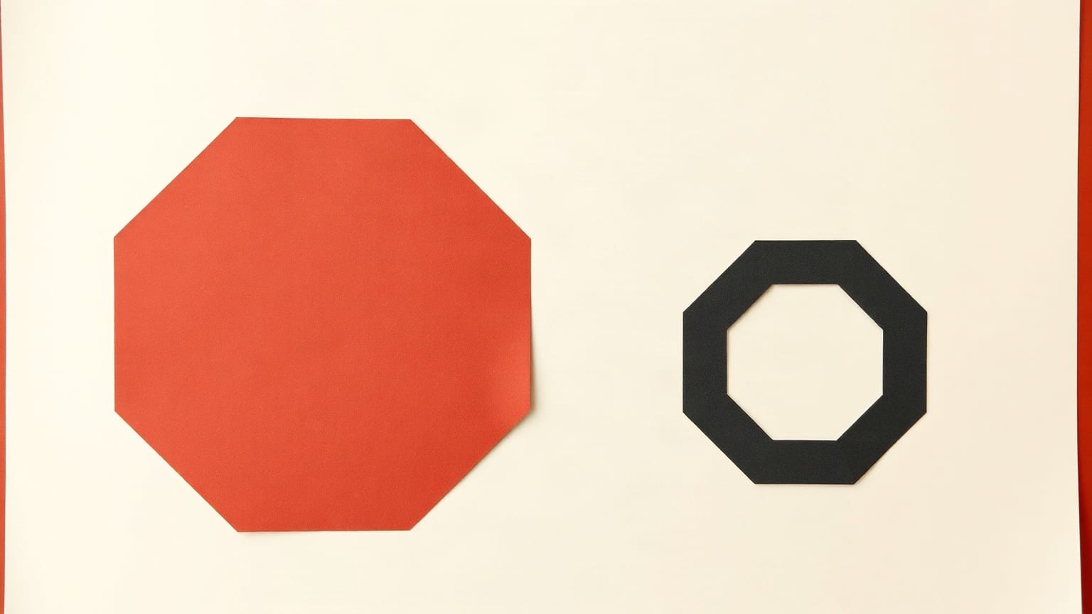 A charcoal paper decagon on a warm off-white ground, with a smaller red hexagon of paper set apart from it